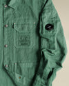 Green lightweight utility jacket by Alessi with snap buttons and prominent Alessi C.P. Company branding.