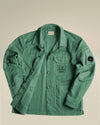 Green textured jacket by Alessi with C.P. Company logos, button-front, and utility pockets.