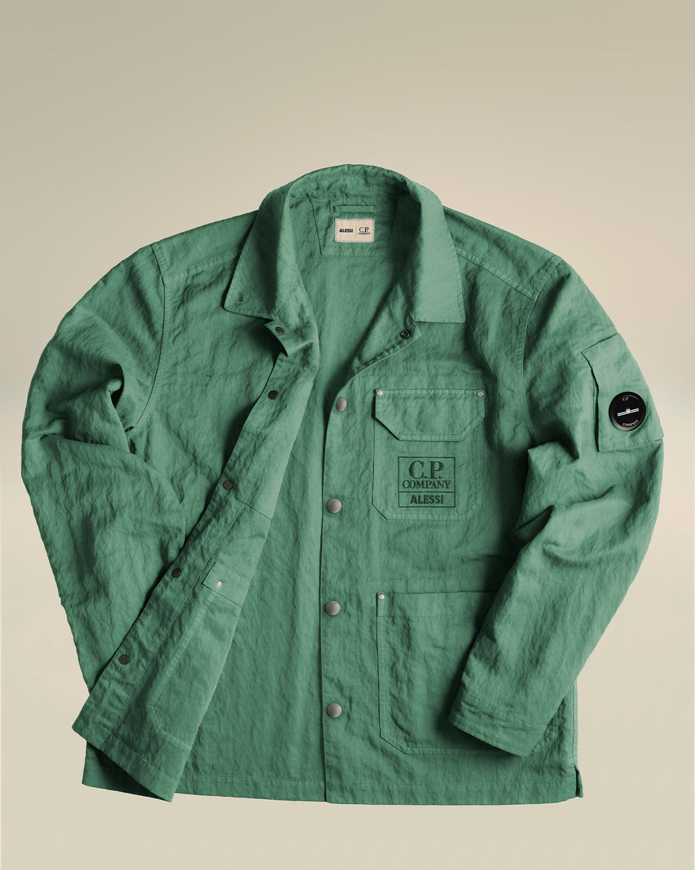 Green textured jacket by Alessi with C.P. Company logos, button-front, and utility pockets.