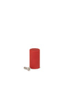 Red cylindrical spare part by Alessi with a silver metallic screw lying next to it.