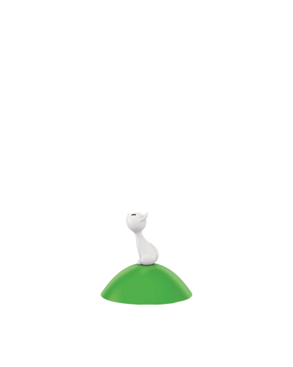 White cat-like Spare Part by Alessi, sitting on a smooth green mound.